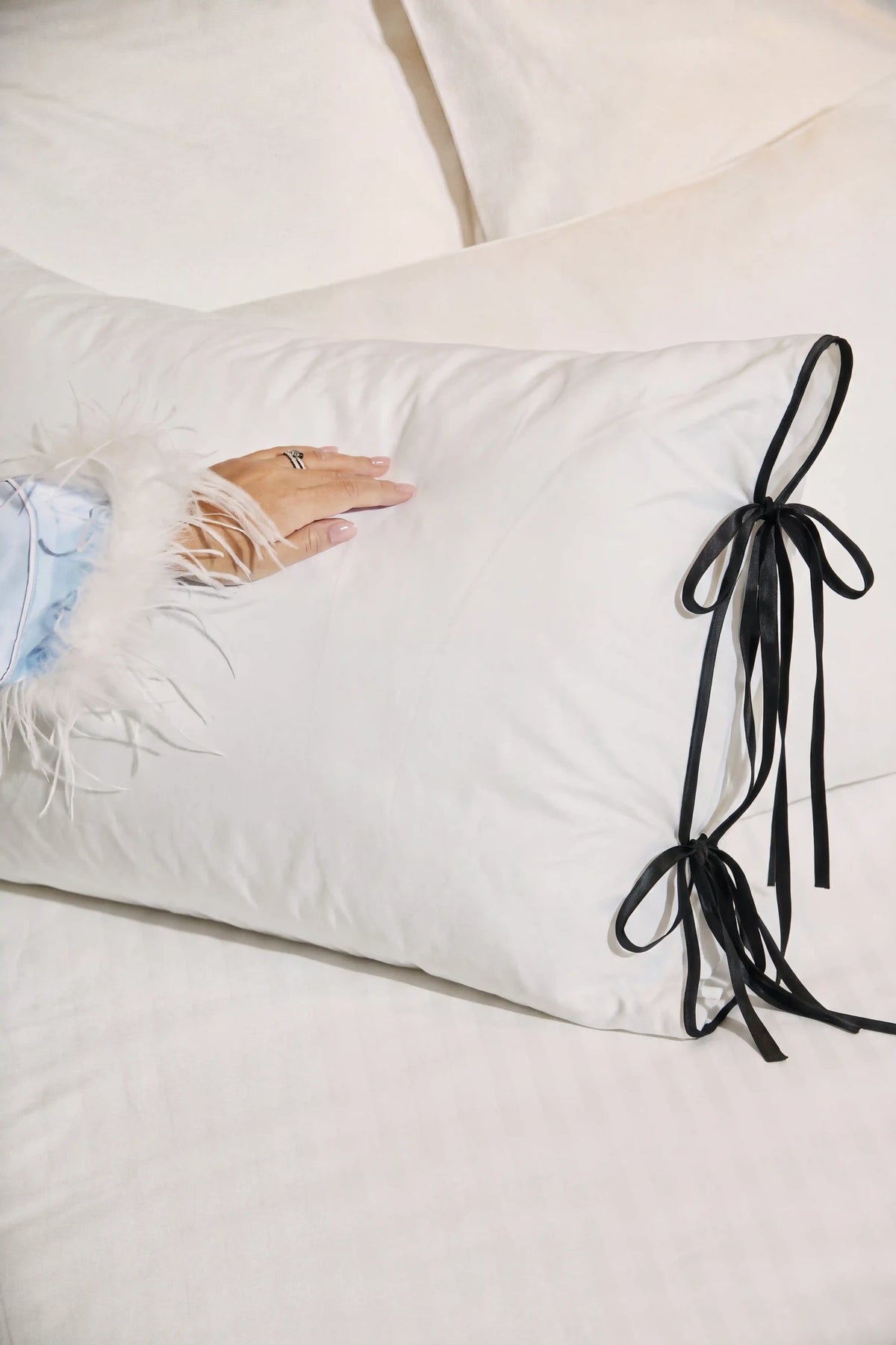 Camille Ribbons Satin Pillowcase in Black showcasing its silky satin texture and subtle sheen