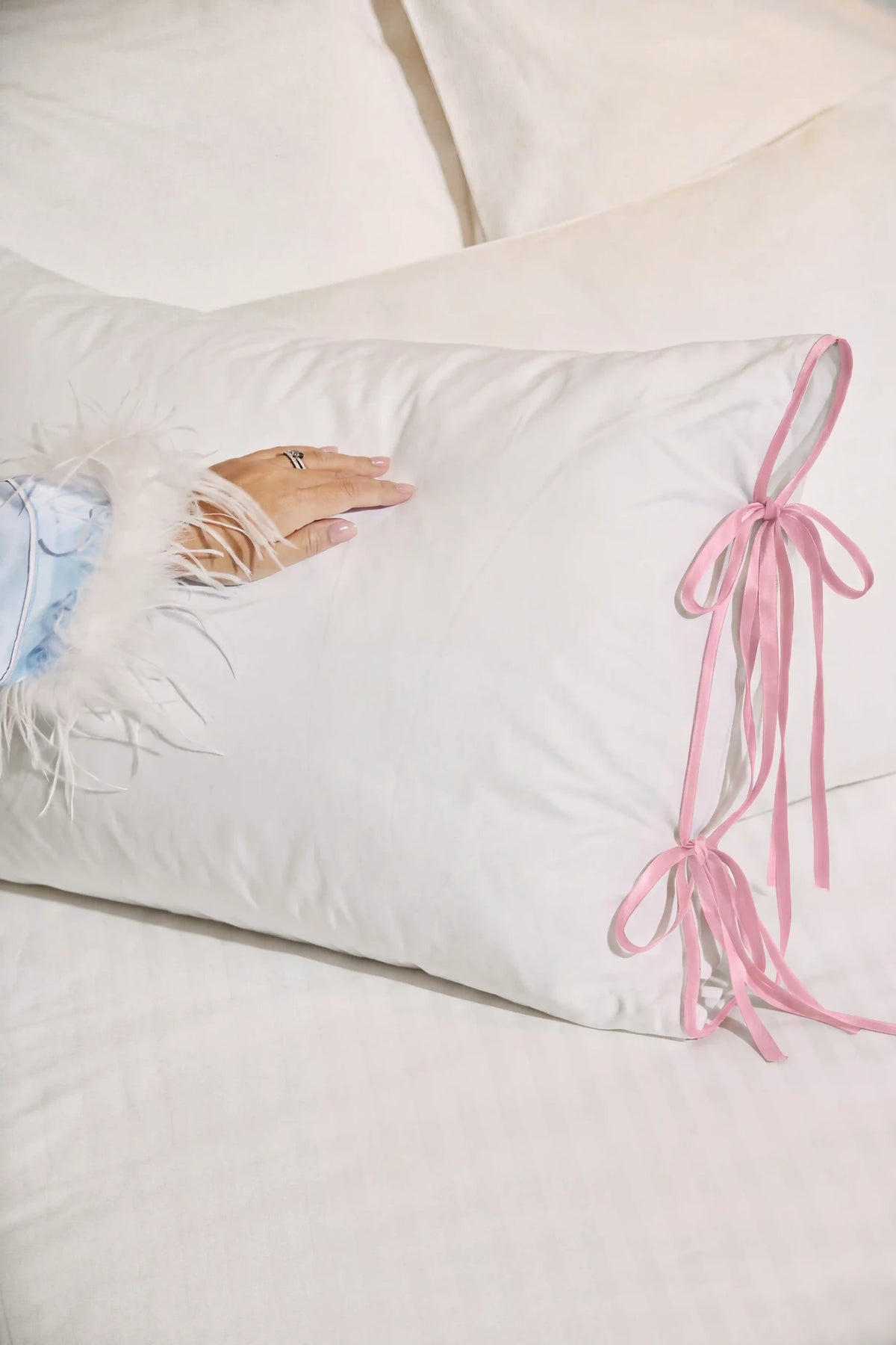 Camille Ribbons Satin Pillowcase in Blush Pink showcasing its silky satin texture and soft pink sheen