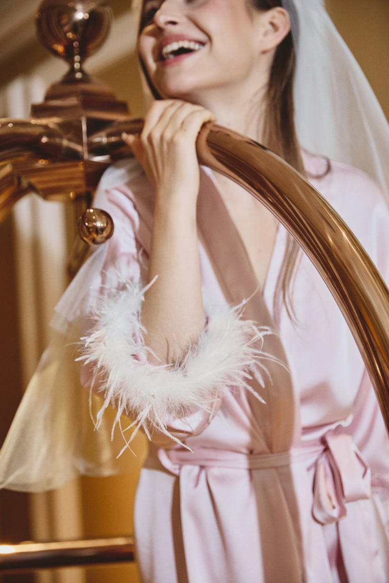 Odette Feather Satin Robe in Blush Pink showcasing its smooth satin fabric and soft pink sheen