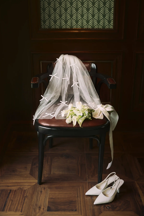 Belle Tiny Bow Veil by Meezily - front view showcasing the delicate bow detail and sheer bridal veil