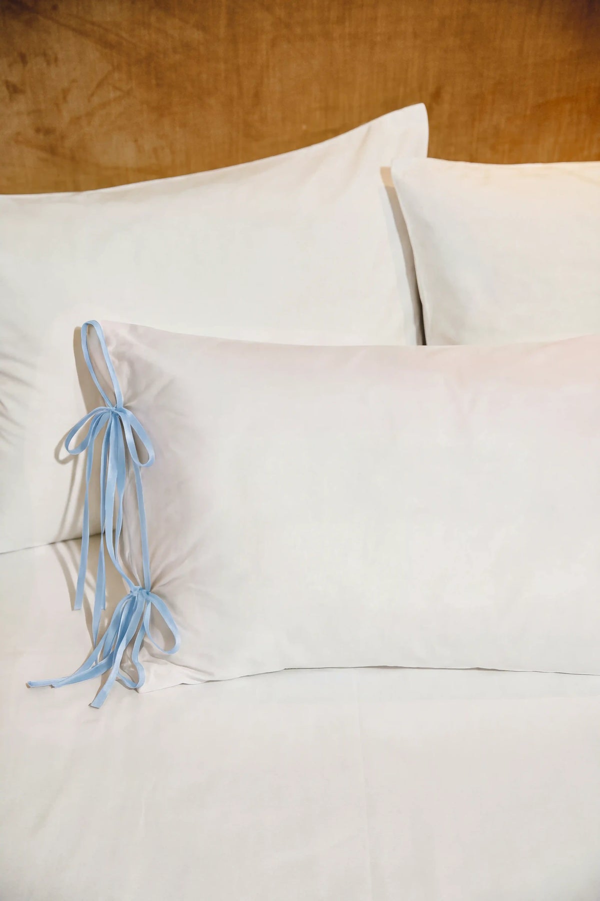 Camille Ribbons Satin Pillowcase in Baby Blue featuring delicate ribbon details and a smooth satin finish