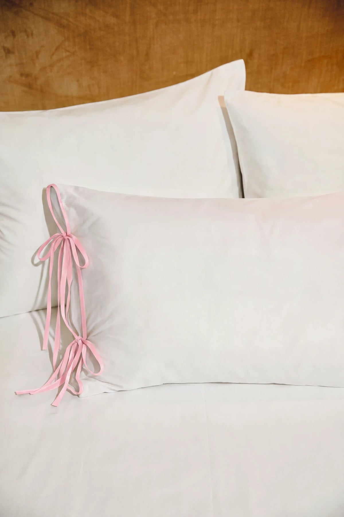 Camille Ribbons Satin Pillowcase in Blush Pink featuring delicate ribbon details and a smooth satin finish