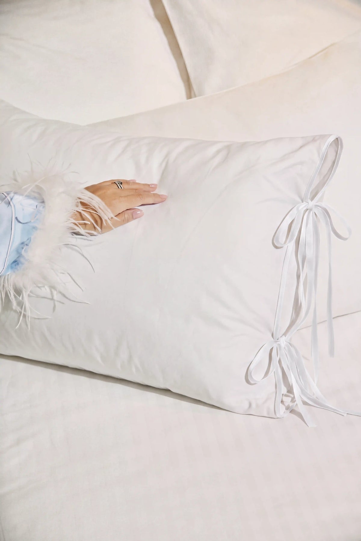 Camille Ribbons Satin Pillowcase in White showcasing its silky satin texture and subtle sheen