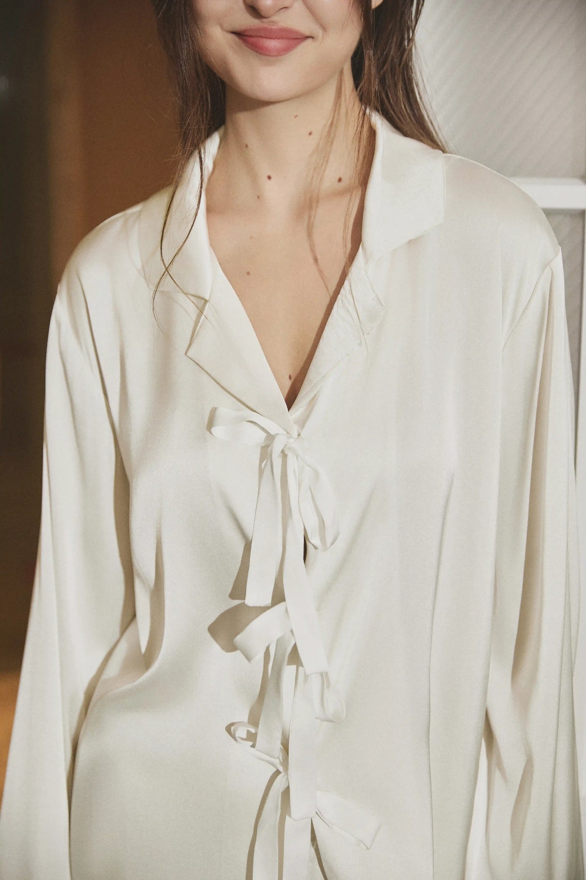 Giselle Feather Bow Satin Pajama Set in Ivory showcasing its decorative bow detail and elegant ivory satin design
