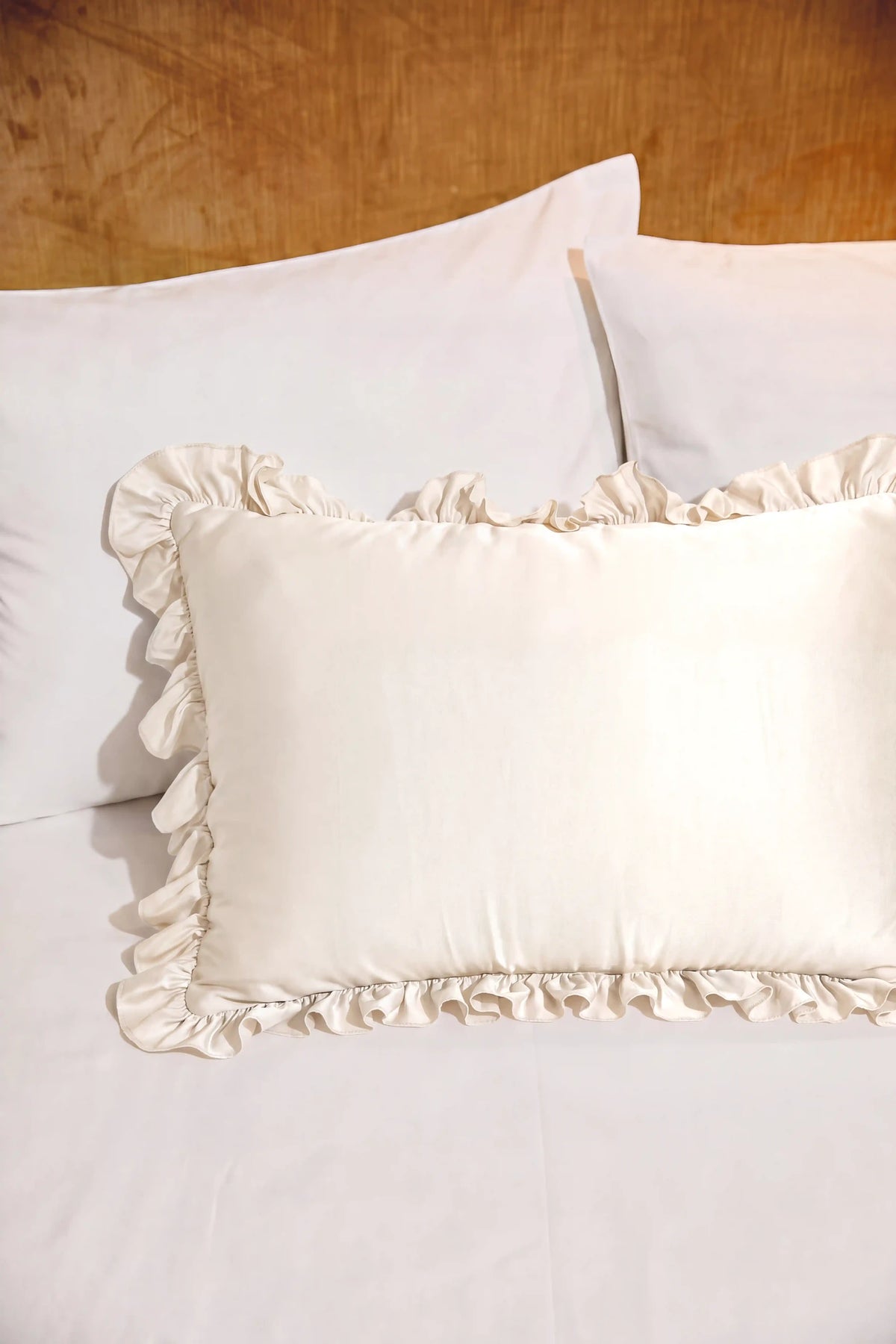 Ruffle Trim Satin Pillowcase in Ivory featuring decorative ruffle trim and a smooth satin finish